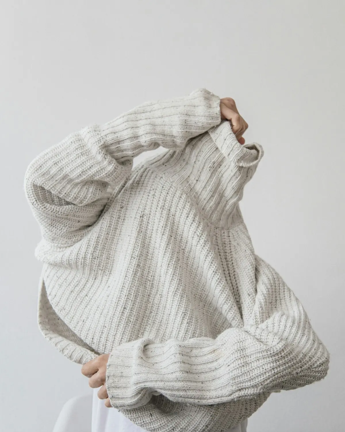 Model in a chunky knit sweater from the RainbowTex flat-knit line